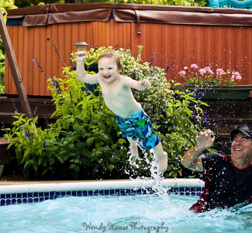 Little boy jumping into water