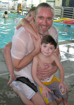 Brendan posing with two children
