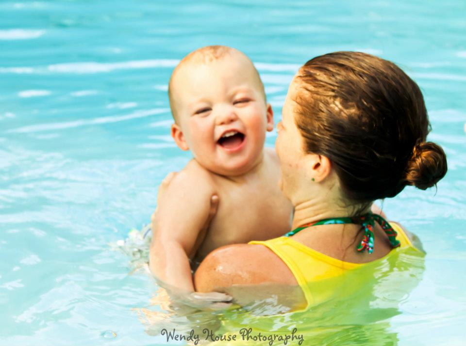 Swim instructor holding toddler